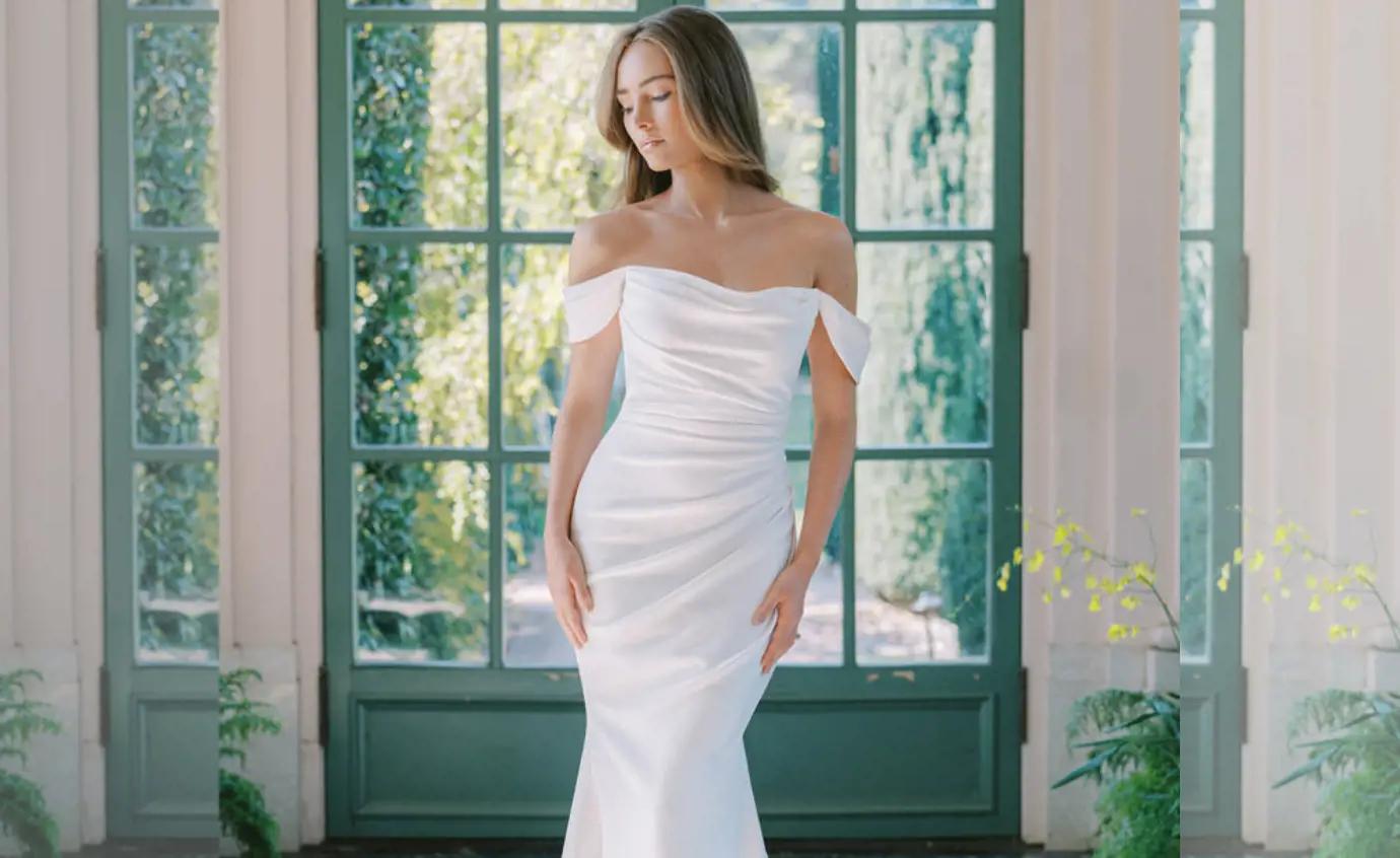 Model wearing a white Fitted style gown
