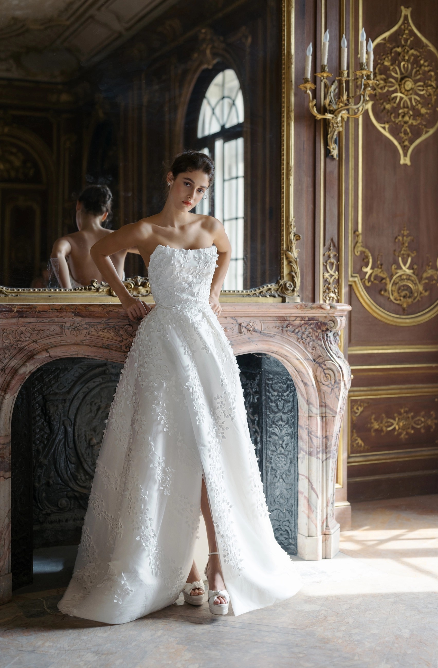 Model wearing a white beaded style gown