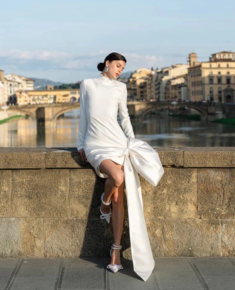 Model wearing a white Monique Lhuillier gown