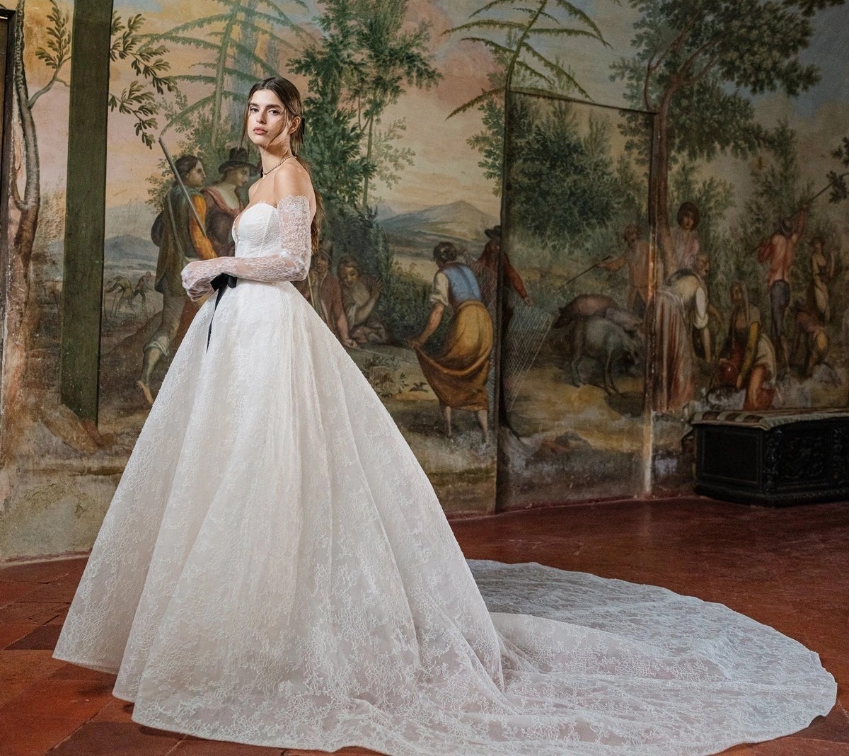 Model wearing a white Monique Lhuillier