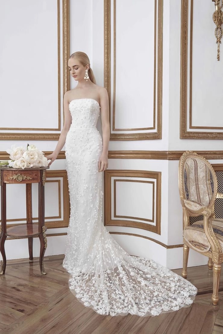 Model wearing a white column style gown